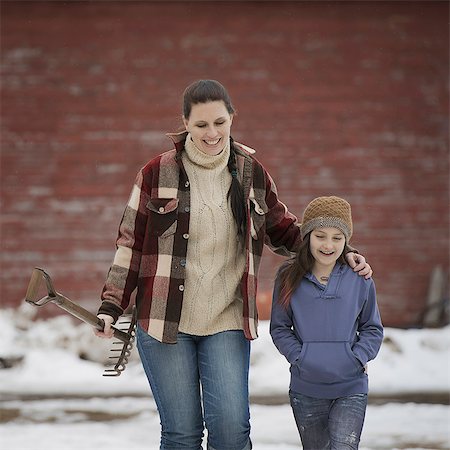 simsearch:6108-06167383,k - An organic farm in winter in New York State, USA. A woman and a young girl walking across a snowcovered farmyard. Stock Photo - Premium Royalty-Free, Code: 6118-07354217