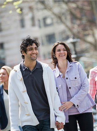 simsearch:649-07437432,k - People outdoors in the city in spring time. New York City park. Two people, a couple holding hands. Stock Photo - Premium Royalty-Free, Code: 6118-07354349