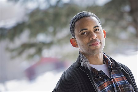 simsearch:6118-07354445,k - Winter scenery with snow on the ground. A man wearing a checked shirt and open jacket. Stock Photo - Premium Royalty-Free, Code: 6118-07354462