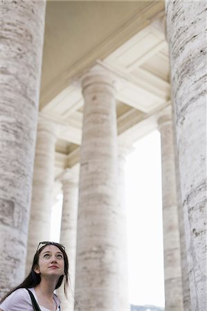 street stone - A woman looking up at the tall pillars and arches of a historic building in Rome. Stock Photo - Premium Royalty-Free, Code: 6118-07354494