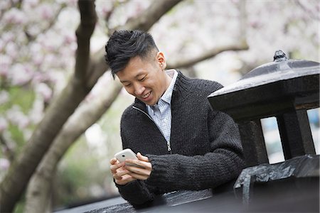 simsearch:6118-07122740,k - City life in spring. A young man outdoors in a city park. Sitting on a bench. Photographie de stock - Premium Libres de Droits, Code: 6118-07354569