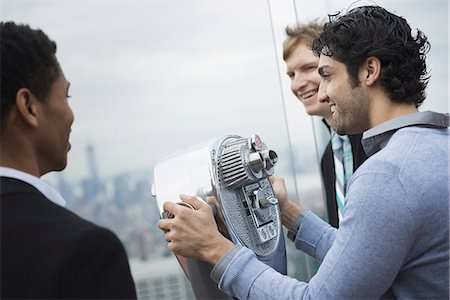 simsearch:6118-07354515,k - New York City. An observation deck overlooking the Empire State Building. Three young men looking over the city. Stock Photo - Premium Royalty-Free, Code: 6118-07354502
