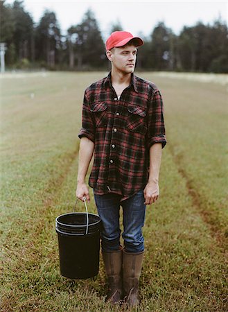 plaid shirt - A cranberry farm in Massachusetts. Crops in the fields. A young man working on the land, harvesting the crop. Stock Photo - Premium Royalty-Free, Code: 6118-07354717