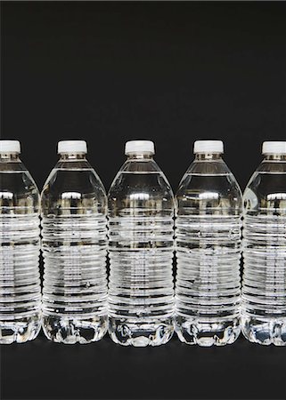 simsearch:6118-07354031,k - Row of clear, plastic water bottles filled with filtered water Stock Photo - Premium Royalty-Free, Code: 6118-07440242