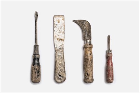 simsearch:6118-07354031,k - Used tools arranged in a row. Well used, worn handles, shaped wooden smooth texture. Metal rusty and marked implements. Stock Photo - Premium Royalty-Free, Code: 6118-07440397