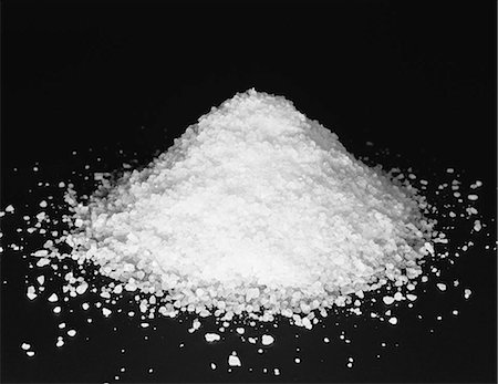 Pile of coarse sea salt grains on a black background. Stock Photo - Premium Royalty-Free, Code: 6118-07440534