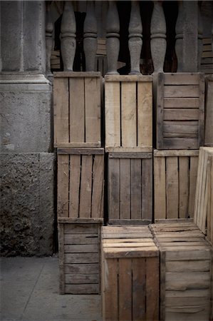A stack of wooden crates, in the corner of a room. Stock Photo - Premium Royalty-Free, Code: 6118-07440814