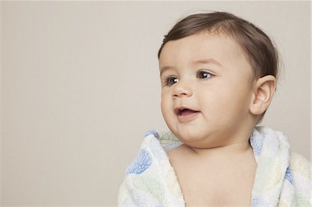 An 8 month old baby boy with a bath towel wrapped around him. Stock Photo - Premium Royalty-Free, Code: 6118-07441019