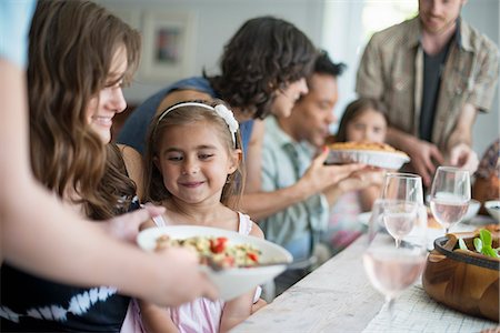 family gathering - A family gathering for a meal. Adults and children around a table. Stock Photo - Premium Royalty-Free, Code: 6118-07769551
