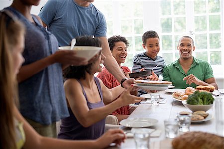 family indoors summer - A family gathering, men, women and children around a dining table sharing a meal. Stock Photo - Premium Royalty-Free, Code: 6118-07769560