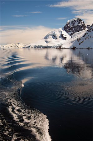 simsearch:6118-08521813,k - Mountains and snowy landscape reflected in calm sea water in the Southern Ocean. Stock Photo - Premium Royalty-Free, Code: 6118-07731835