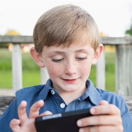 A young boy outdoors. Stock Photo - Premium Royalty-Free, Code: 6118-07732044