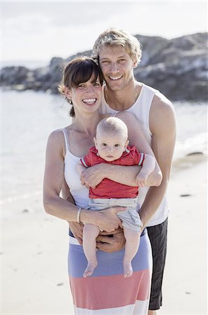 A family day out on the beach. Two people and a baby. Stock Photo - Premium Royalty-Free, Code: 6118-07808952