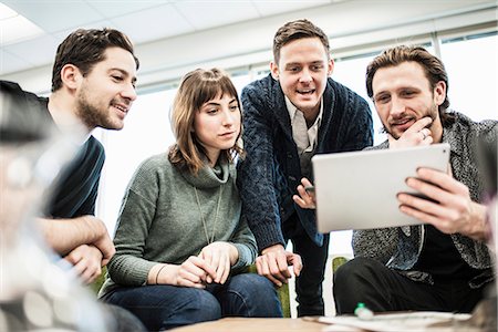 simsearch:614-06718107,k - Four people, colleagues at a meeting, and one man sharing a tablet with the group. Stock Photo - Premium Royalty-Free, Code: 6118-08066741