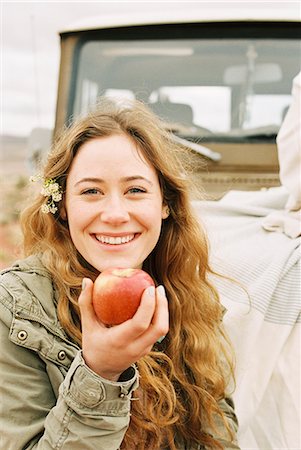 simsearch:6118-08140197,k - A young woman holding out a red skinned apple. Stock Photo - Premium Royalty-Free, Code: 6118-08140167