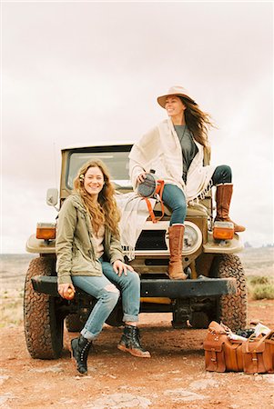simsearch:6118-08140197,k - Two women sitting on the front of a jeep, on a road trip. Stock Photo - Premium Royalty-Free, Code: 6118-08140166
