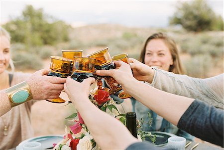 simsearch:6118-08140197,k - A group of women raising their glasses to toast each other at an outdoor meal. Stock Photo - Premium Royalty-Free, Code: 6118-08140194