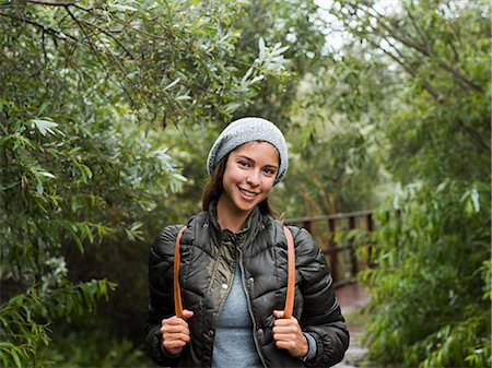 simsearch:6118-08129648,k - A young woman with beret and rucksack walking on a path. Foto de stock - Sin royalties Premium, Código: 6118-08129664