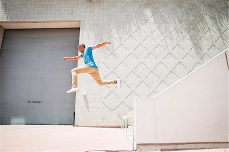 simsearch:6118-08129648,k - Young man jumping in the air down a stairway. Foto de stock - Sin royalties Premium, Código: 6118-08129695