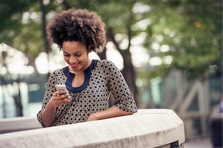 simsearch:6118-08243810,k - A woman in a park checking her cell phone Stock Photo - Premium Royalty-Free, Code: 6118-08243830