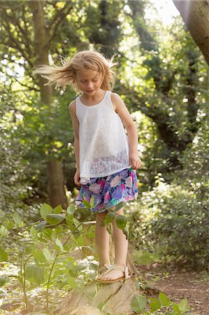 Young girl playing in a forest. Stock Photo - Premium Royalty-Free, Code: 6118-08282323