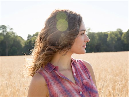 person thinking - A young woman standing in a field of tall ripe corn. Stock Photo - Premium Royalty-Free, Code: 6118-08220593