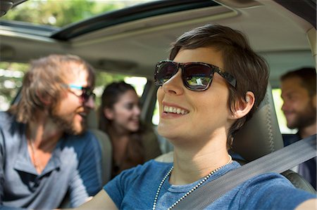 A group of people inside a car, on a road trip. View to the back seat, four passengers. Stock Photo - Premium Royalty-Free, Code: 6118-08226931
