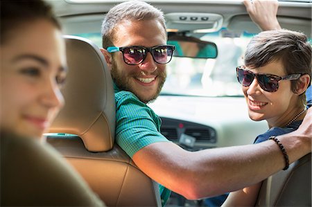 A group of people inside a car, on a road trip. View from the back seat. Stock Photo - Premium Royalty-Free, Code: 6118-08226935