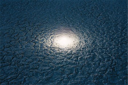 Small bright glowing light on the surface of salt flats. Stock Photo - Premium Royalty-Free, Code: 6118-08313760