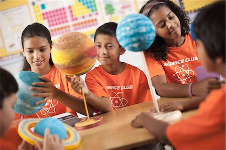 symbol for students education - A group of girls and boys wearing the teeshirt of the Science Club, making molecular structure models. Stock Photo - Premium Royalty-Free, Code: 6118-08488272