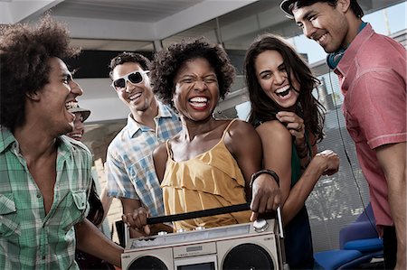simsearch:6118-08140197,k - Five friends, young people with a large portable music player, having a party. Stock Photo - Premium Royalty-Free, Code: 6118-08488218