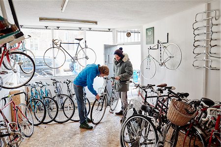 shop - Two young men in a cycle shop, talking. Stock Photo - Premium Royalty-Free, Code: 6118-08488456