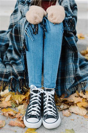 sitting in jeans - A young person sitting on a step with a warm plaid shawl around her. Stock Photo - Premium Royalty-Free, Code: 6118-08521841