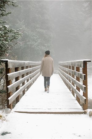 simsearch:6118-08521813,k - A woman walking on a footbridge in the mountains in snow. Stock Photo - Premium Royalty-Free, Code: 6118-08521817
