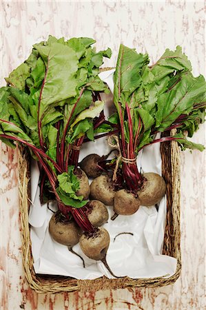 simsearch:6118-07808971,k - A shot of bundles of beets in a basket on a wooden surface, seen from above. Stock Photo - Premium Royalty-Free, Code: 6118-08842019