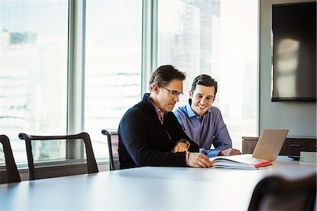 simsearch:614-08030536,k - Two men at a table in a meeting room looking at a laptop computer. Stock Photo - Premium Royalty-Free, Code: 6118-08842171