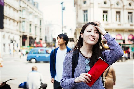 european tourist - Young Japanese man and woman enjoying a day out in London, walking near Piccadilly Circus. Stock Photo - Premium Royalty-Free, Code: 6118-08827422