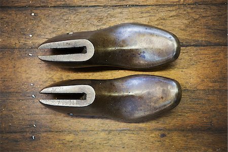 simsearch:6118-08521776,k - A pair of metal shoe forms, shoe lasts, in a shoemaker's workshop. Stock Photo - Premium Royalty-Free, Code: 6118-08947679
