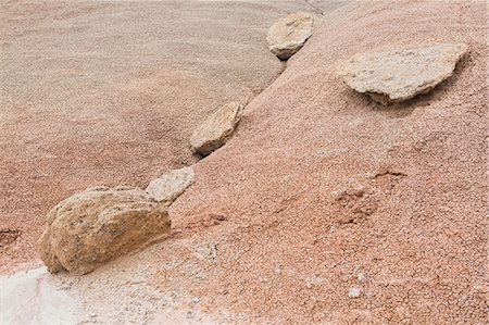 simsearch:6118-07353866,k - Rocks and boulders on the Bentonite Hills of Cathedral Valley, coloured rock strata and formations of the Cainville Wash in Capitol Reef national park in Utah. Stock Photo - Premium Royalty-Free, Code: 6118-08947917