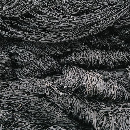 simsearch:6118-08910527,k - Close up of a pile of tangled up commercial fishing nets. Stock Photo - Premium Royalty-Free, Code: 6118-08910513
