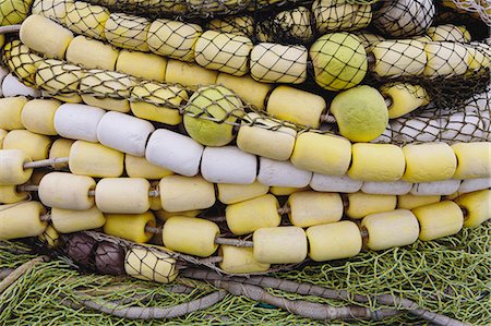 simsearch:6118-08910527,k - Close up of a pile of tangled up commercial fishing nets with floats attached. Stock Photo - Premium Royalty-Free, Code: 6118-08910517