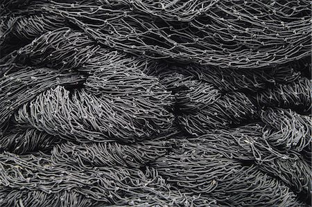 simsearch:6118-08910527,k - Close up of a pile of tangled up commercial fishing nets. Foto de stock - Sin royalties Premium, Código: 6118-08910515