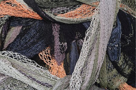 simsearch:6118-08910527,k - Close up of a pile of tangled up commercial fishing nets. Foto de stock - Sin royalties Premium, Código: 6118-08910523