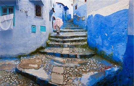 road painting image - Rear view of person climbing cobblestone steps lined with blue washed traditional North African houses. Stock Photo - Premium Royalty-Free, Code: 6118-09076623