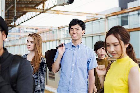 simsearch:649-06621987,k - Small group of people standing on the platform of a subway station, Tokyo commuters. Stock Photo - Premium Royalty-Free, Code: 6118-09079656