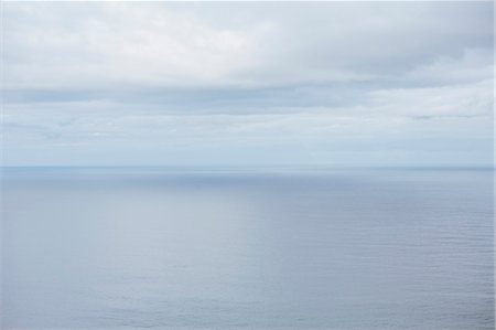 simsearch:614-05955439,k - View from the land over the ocean, to the horizon where the sky meets the sea. Light clouds. Stock Photo - Premium Royalty-Free, Code: 6118-09018258