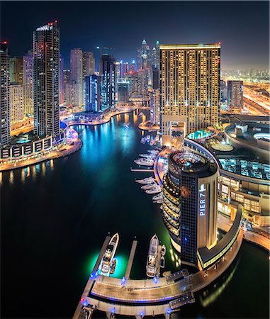 simsearch:649-07710289,k - Cityscape of Dubai, United Arab Emirates at dusk, with illuminated skyscrapers lining the Dubai Creek. Stock Photo - Premium Royalty-Free, Code: 6118-09028250