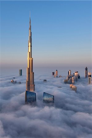 View of the Burj Khalifa and other skyscrapers above the clouds in Dubai, United Arab Emirates. Stock Photo - Premium Royalty-Free, Code: 6118-09028257