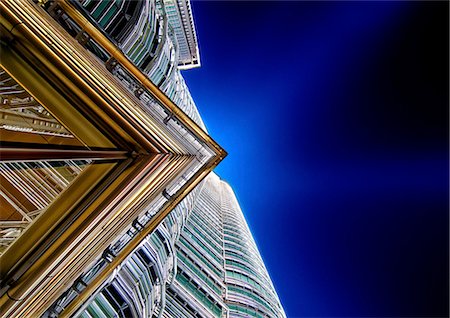 simsearch:841-08797696,k - Low angle close up of architectural detail on Petronas Towers in Kuala Lumpur, Malaysia at night. Stock Photo - Premium Royalty-Free, Code: 6118-09028267
