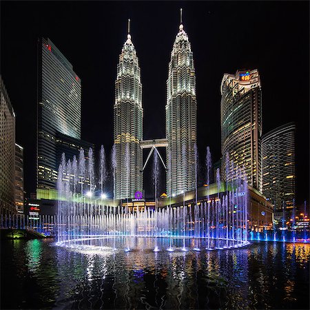 simsearch:841-08797696,k - Illuminated Petronas Towers Kuala Lumpur, Malaysia at night. Fountain in foreground. Stock Photo - Premium Royalty-Free, Code: 6118-09028271